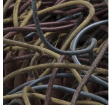 Mess of tangled electrical wires in computer plugboard.