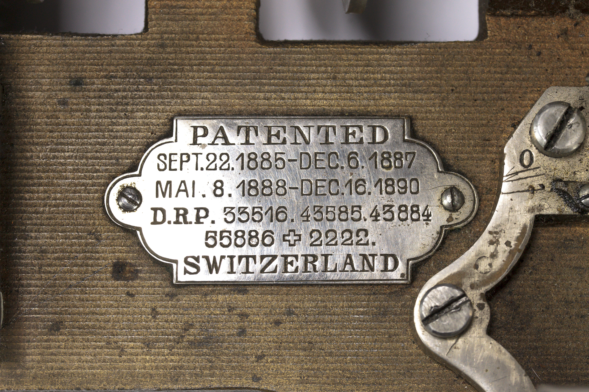 Close up of metal plaque with patent information on it