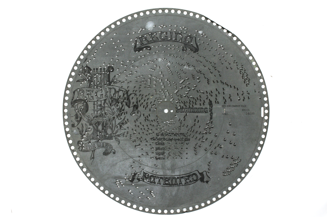 Large zinc  disc with punched out pins and Regina branding printed on face for Regina Music Box