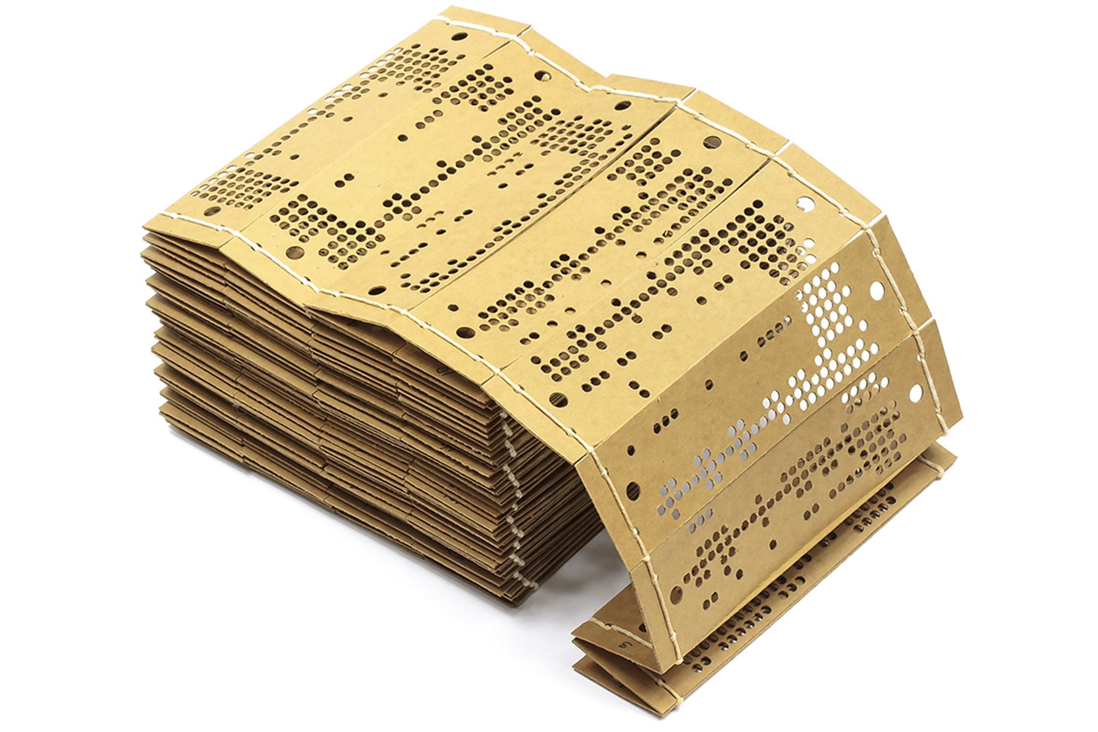 A stack of cards for a Jacquard loom punched with holes in rows and strung together with string